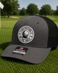 Golf trucker patch hat, dark gray front with white logo patch and black mesh back