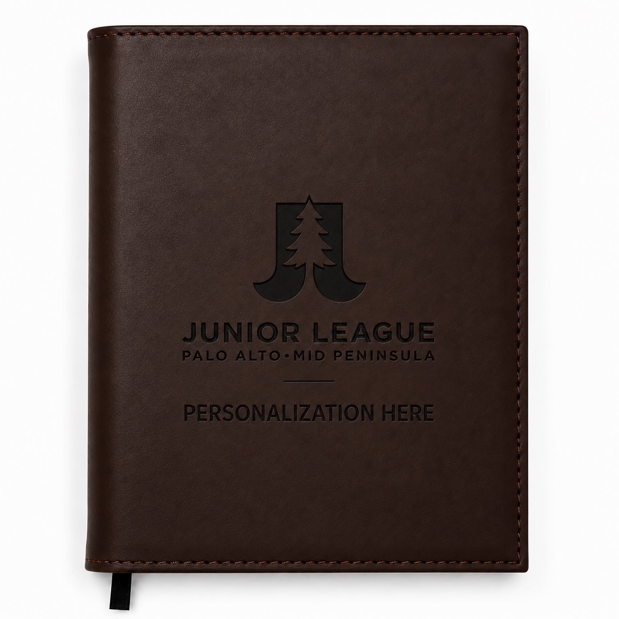 Brown leather notebook with engraved text on a white background