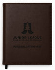 Brown leather notebook with engraved text on a white background