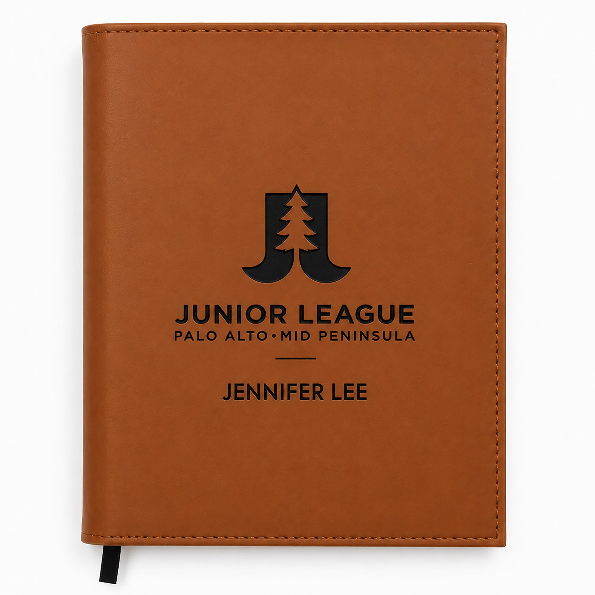 Brown notebook with 'Junior League' logo and text on a white background