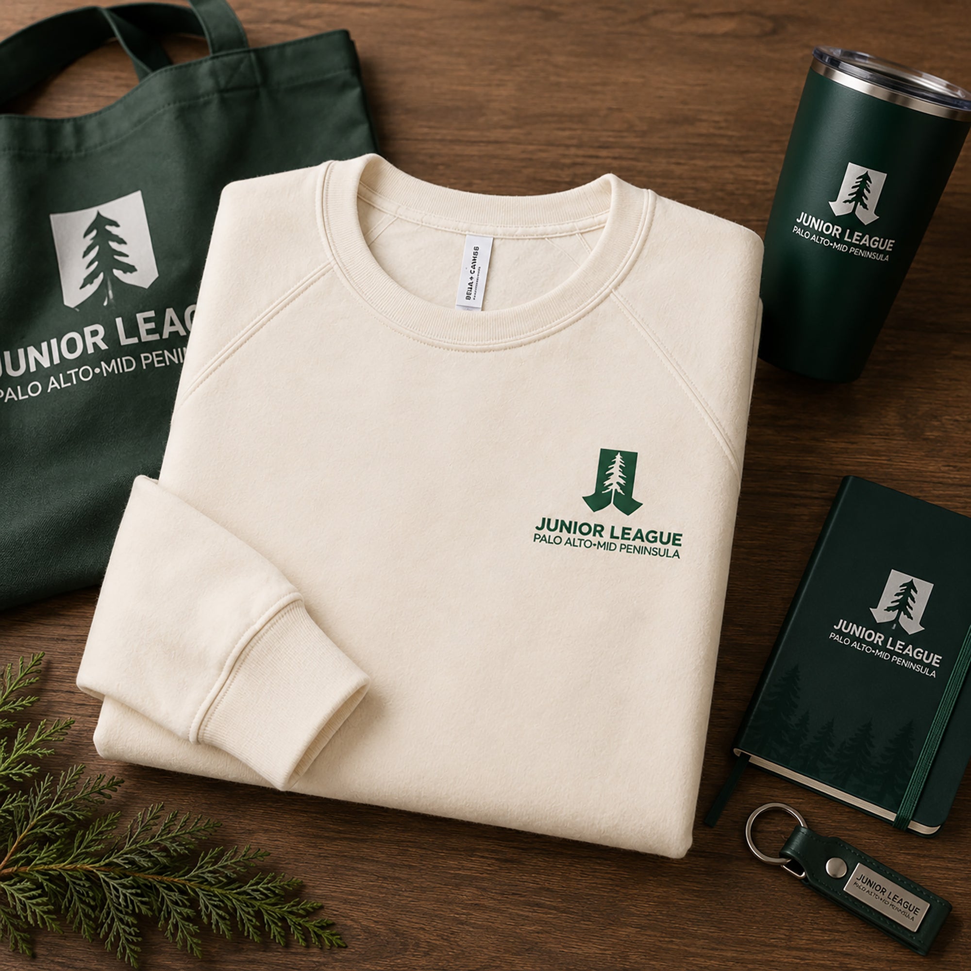 Natural raglan sweatshirt with chest logo, folded with accessories
