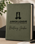 Green notebook with engraved text and logo on a wooden surface