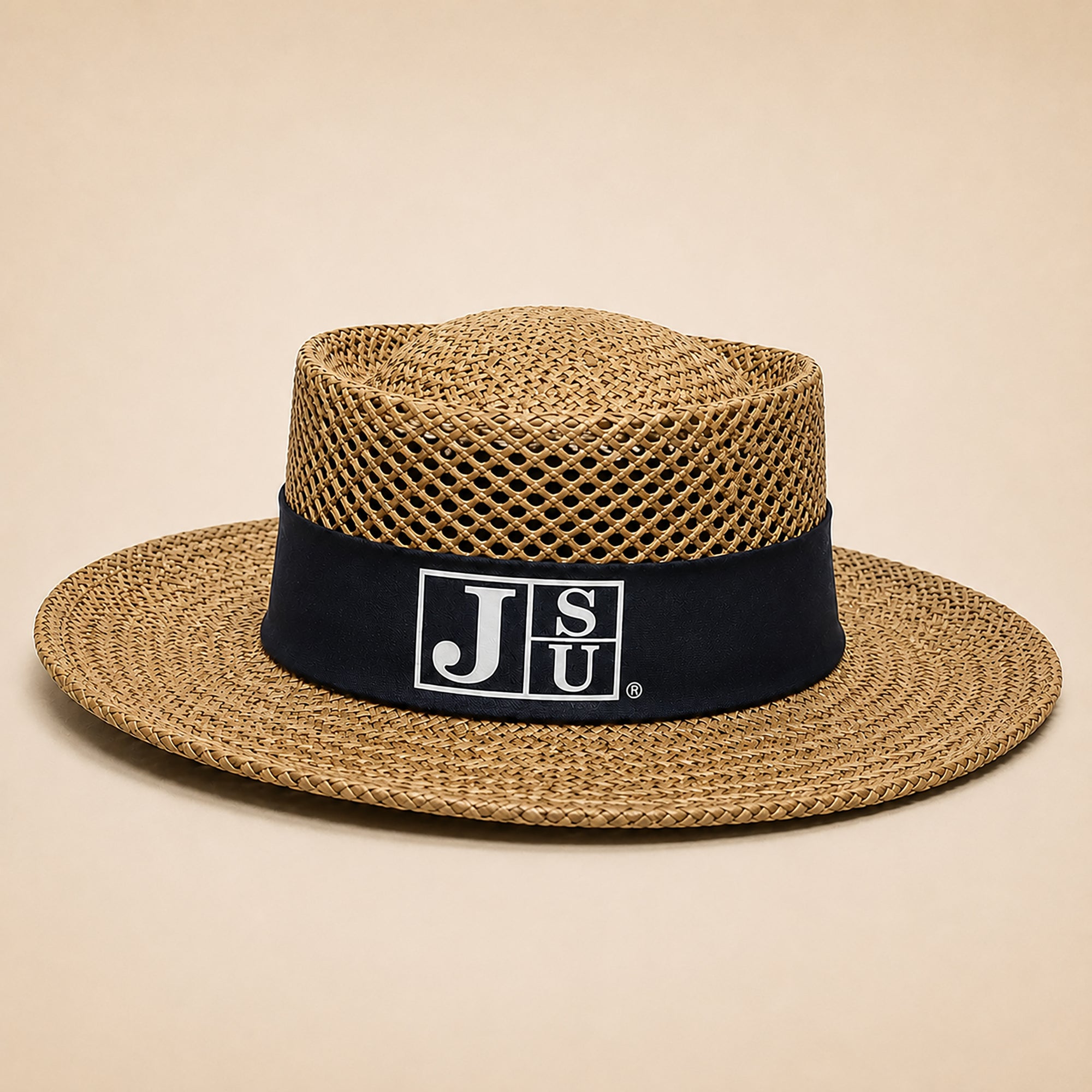 A straw fedora hat with a black band featuring the white 'JSU' logo, set against a solid beige background.