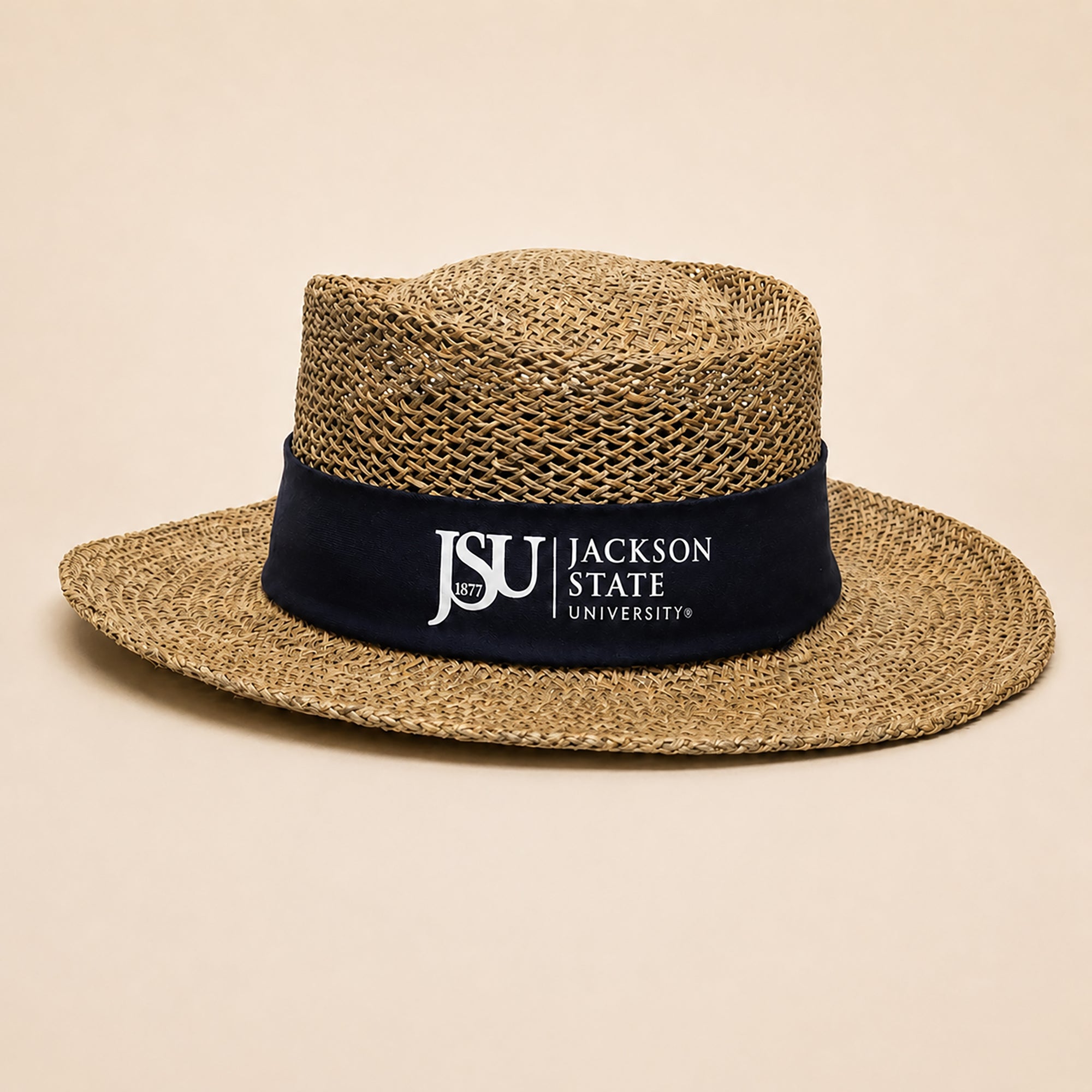A woven straw fedora-style hat with a navy blue band featuring the white text 'JSU JACKSON STATE UNIVERSITY'.
