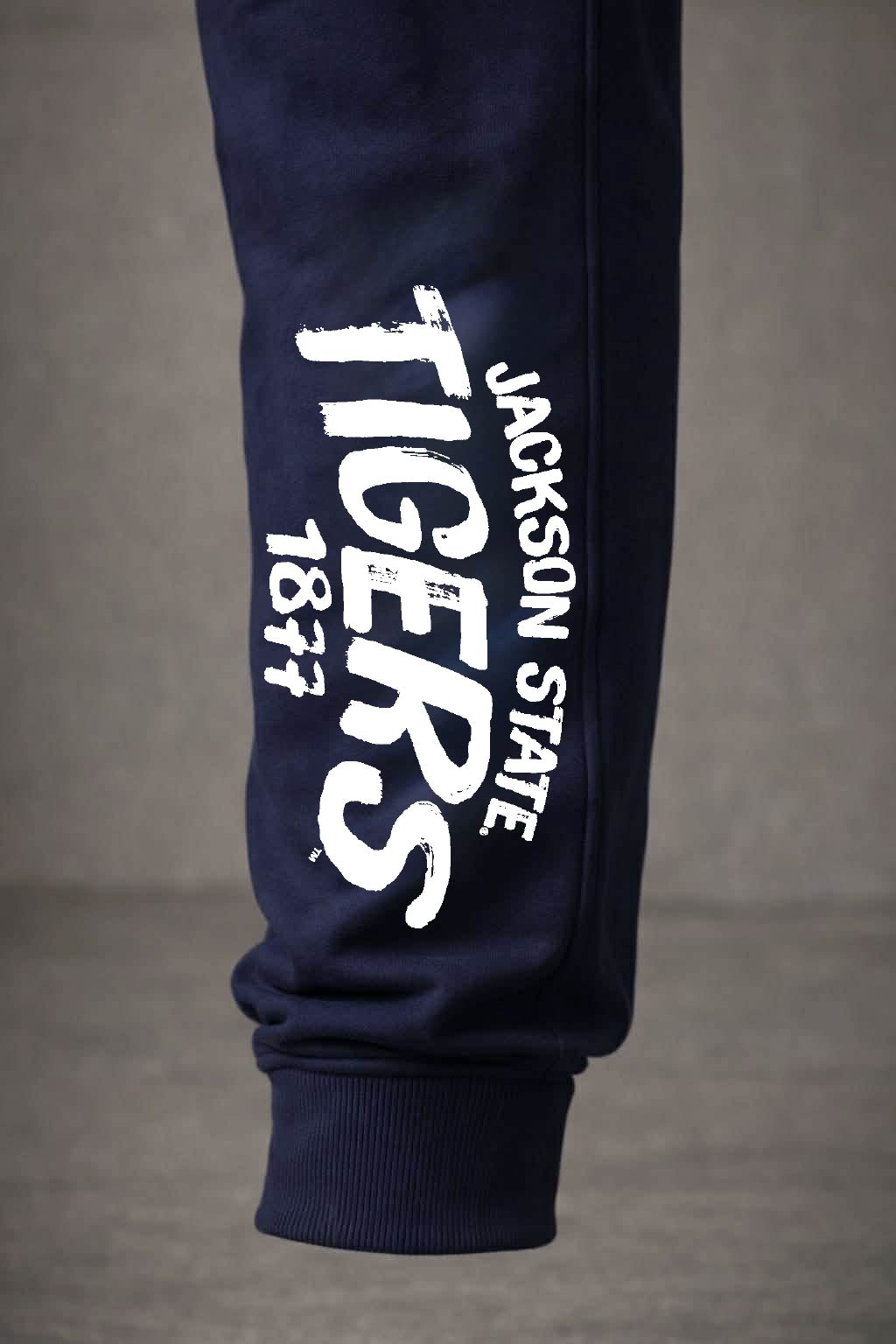 Close up detailed and texture shot featuring JSU Staple Arch design on navy blue jogger pant