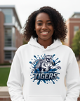 Black woman wearing a white hoodie with a Jackson State Tigers Blue Blitz design standing outdoors.