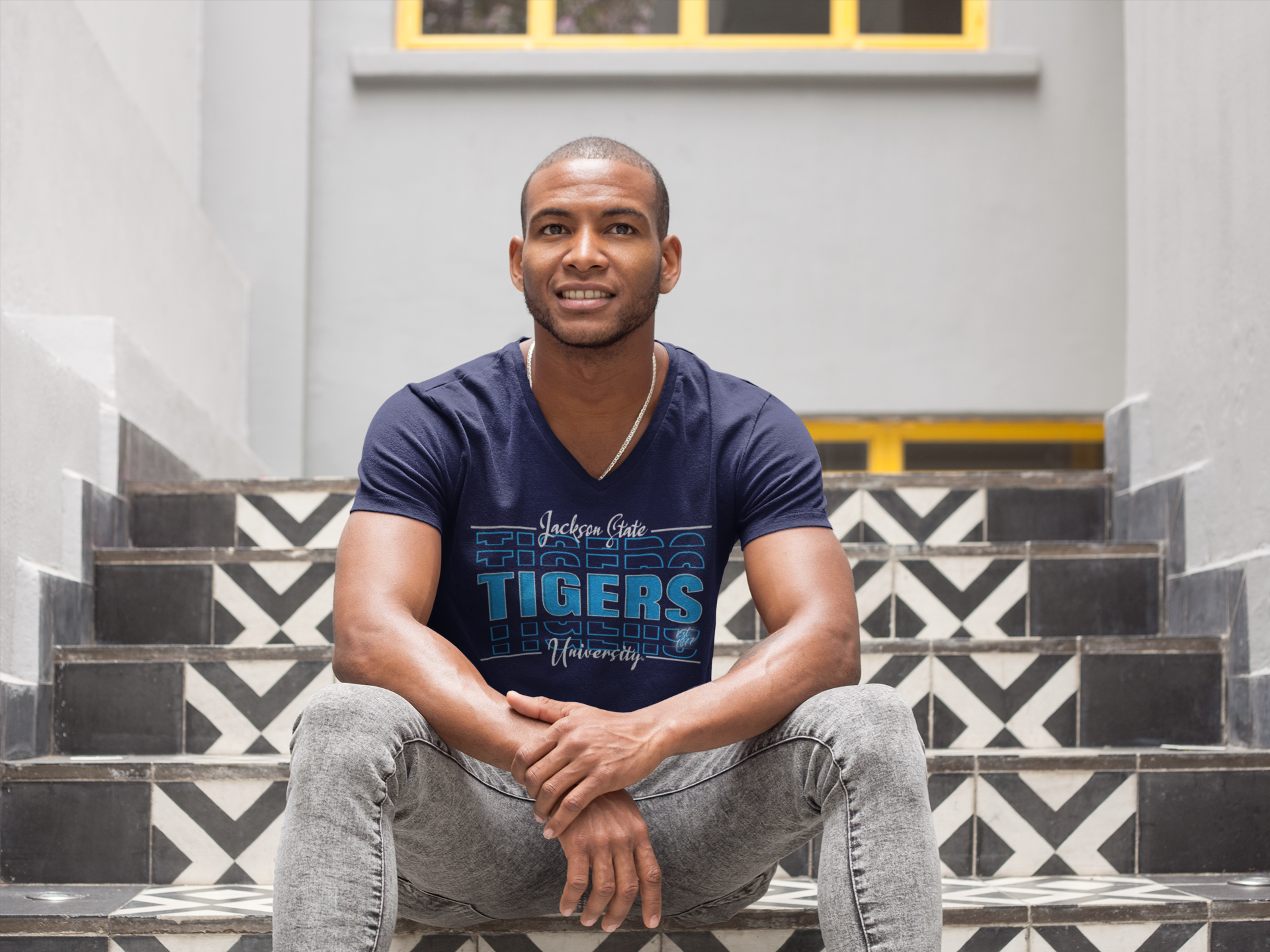 Man Sitting on Steps in Blue V-Neck JSU Authentic Streetwear T-Shirt