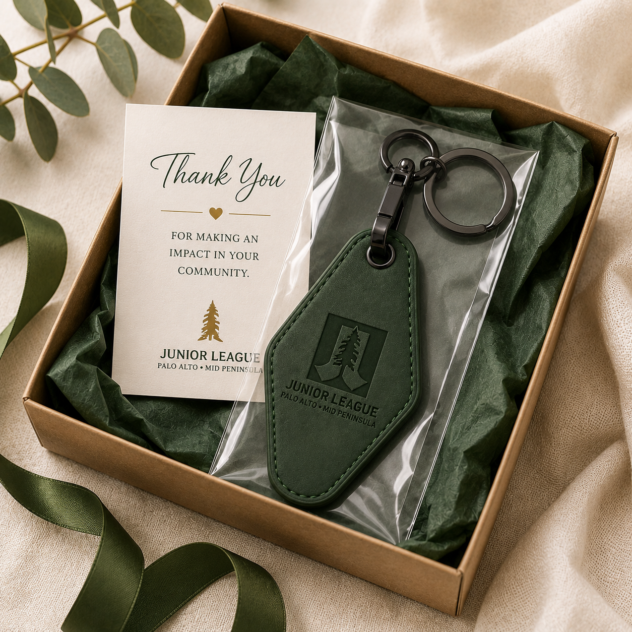 Junior League engraved motel keychain packaged in gift box with thank you card and green tissue paper