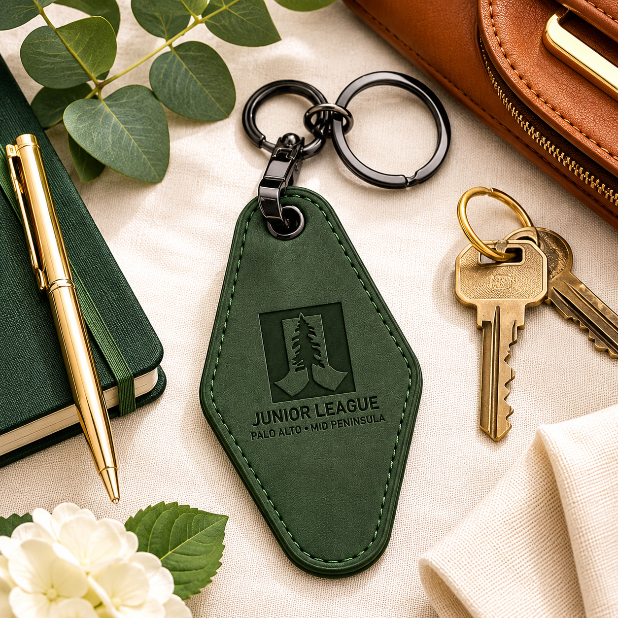 Front and back view of personalized Junior League motel keychain with custom engraved member name and title