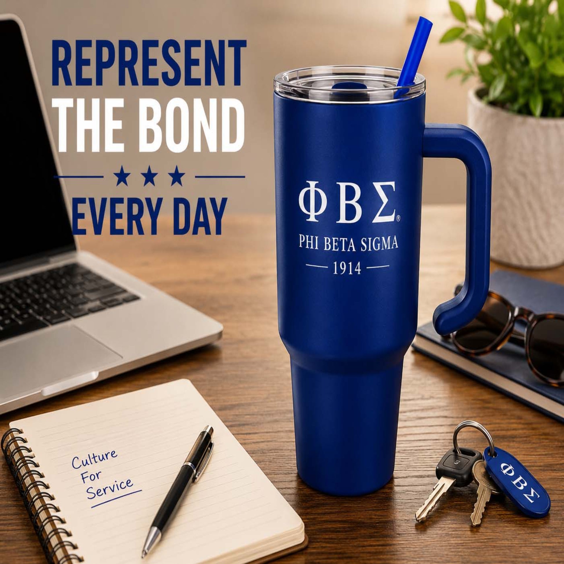 Blue Phi Beta Sigma mug on a desk with laptop, notebook, and keys.