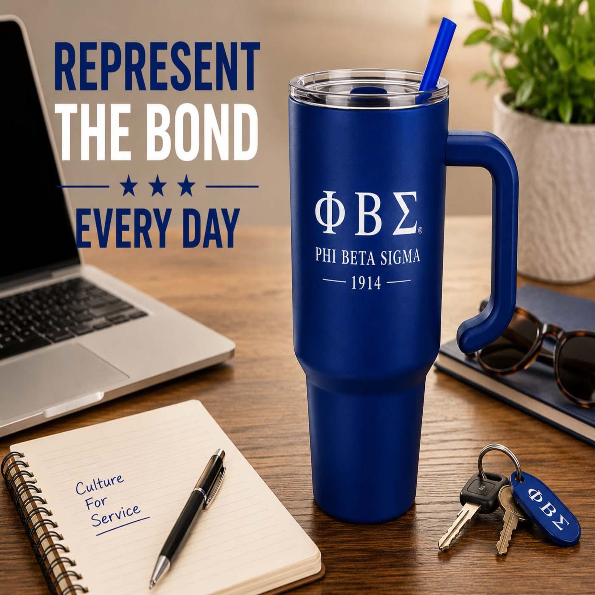 Blue Phi Beta Sigma mug on a desk with laptop, notebook, and keys.