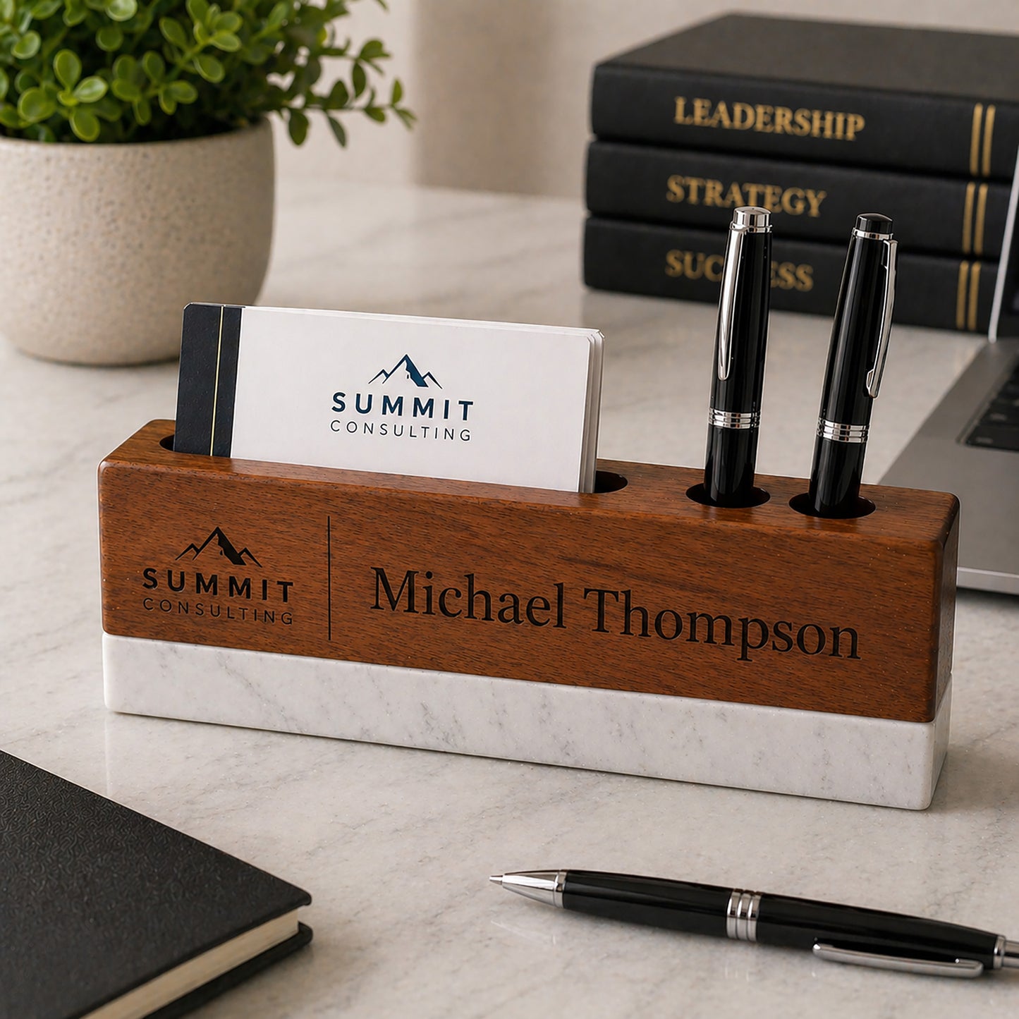 Wooden desk organizer with Summit Consulting logo, business cards, and pens on a desk.
