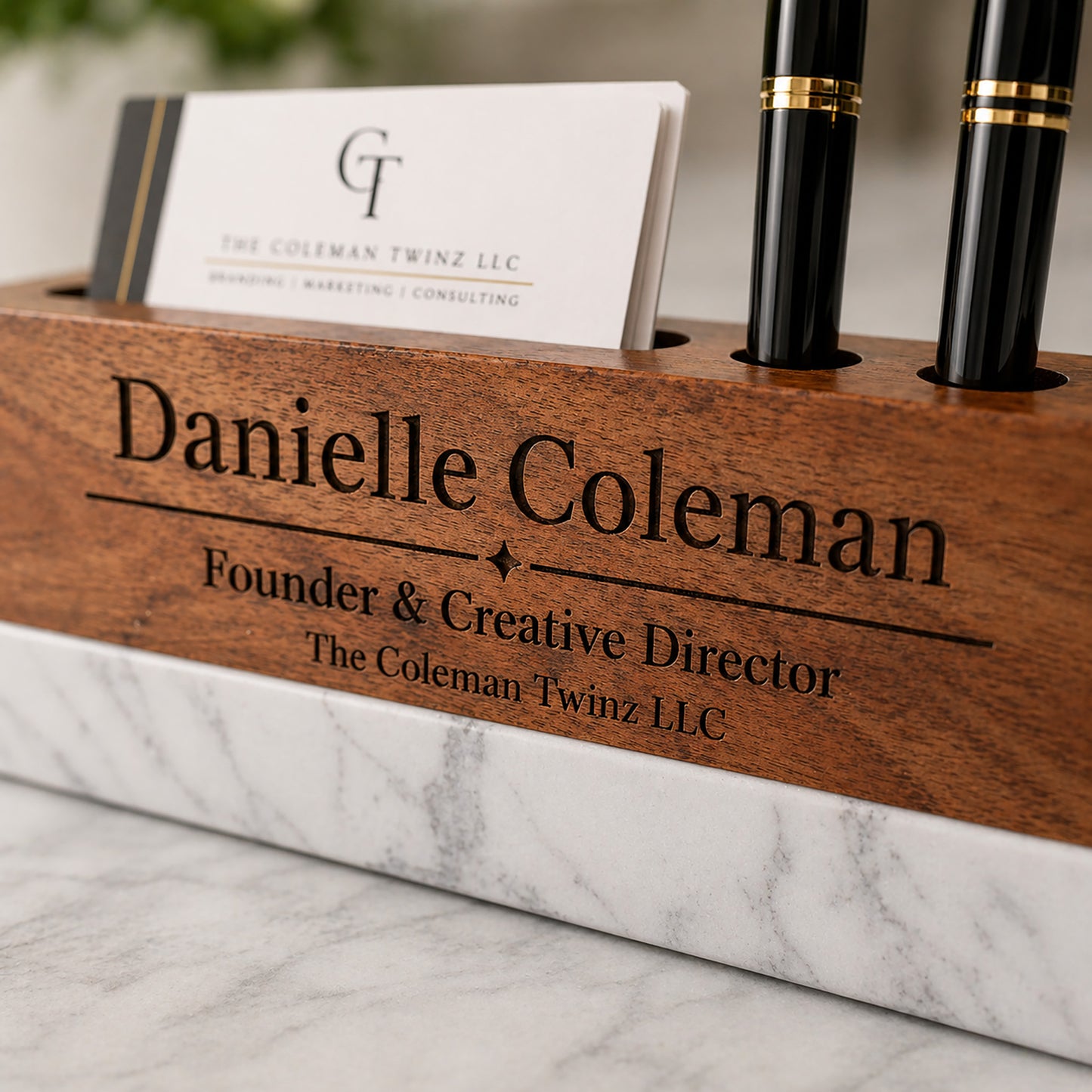 Wooden desk organizer with personalized engraving on a marble surface