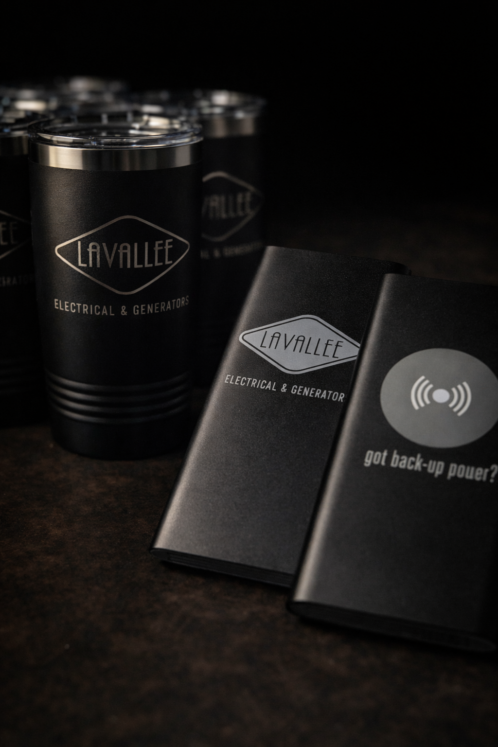 Black insulated cups with 'Lavallee' branding on a dark surface.