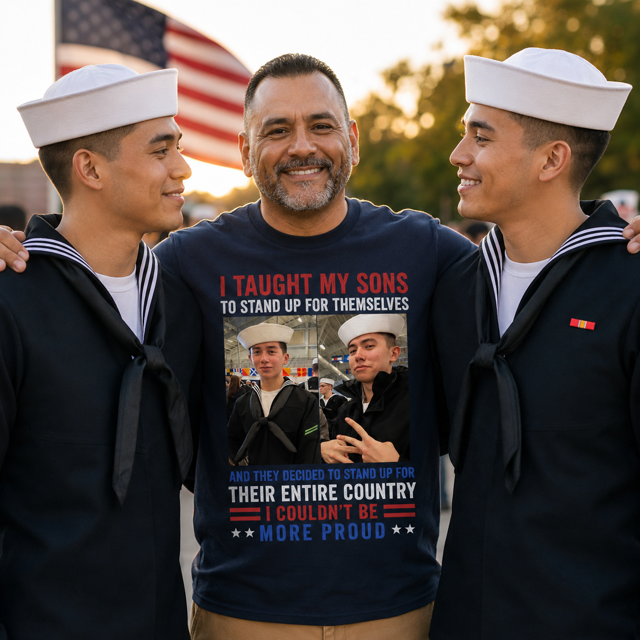 Proud father wearing a personalized Navy parent t-shirt stands between his two sons in United States Navy dress uniforms during a graduation celebration. The custom shirt features photos of both sailors and a patriotic message honoring their service. American flag blurred in the background with warm golden hour lighting.