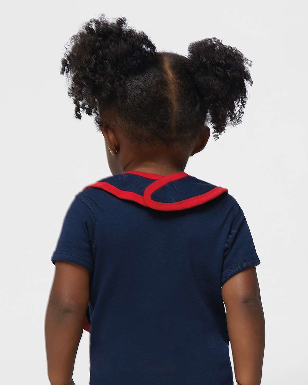 Baby back view wearing navy shirt with red collar trim