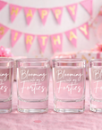 Four shot glasses with 'Blooming into my Forties' text on a birthday-themed background with balloons and cake.