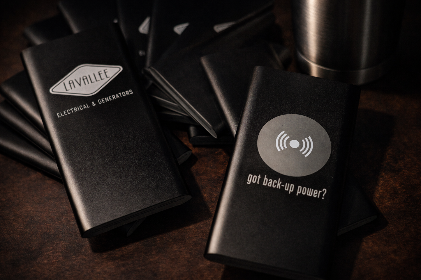 Black power generation packs with 'Lavallee Electrical & Generators' branding on a dark surface.