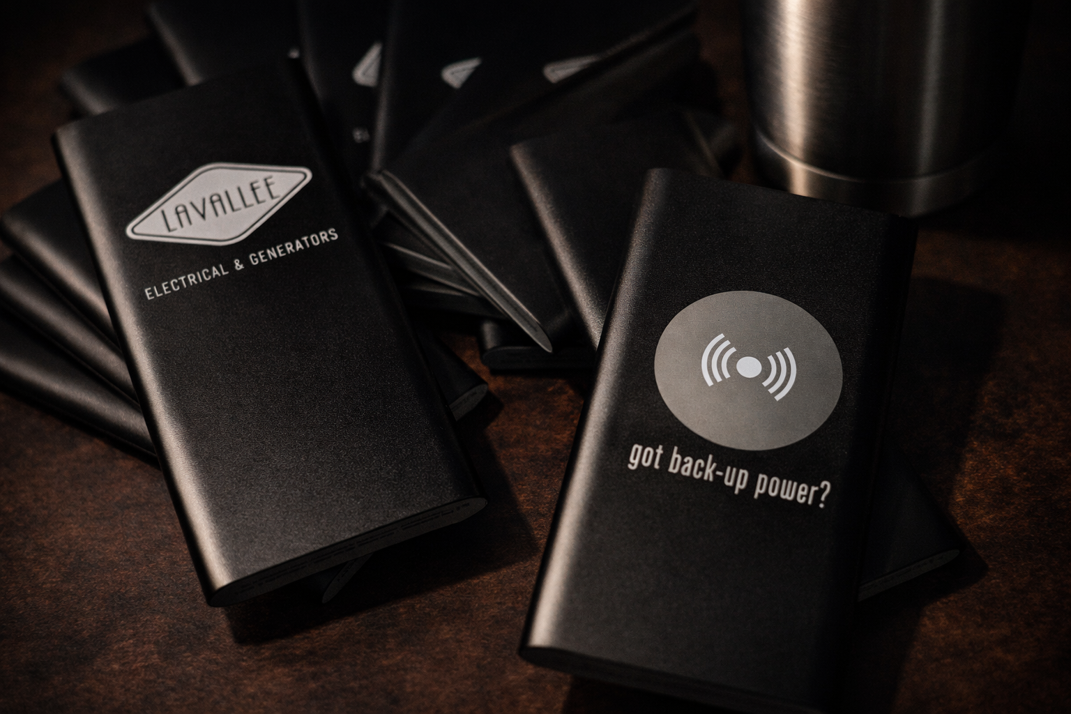 Black power generation packs with 'Lavallee Electrical & Generators' branding on a dark surface.