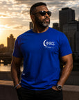 Black professional man wearing Phi Beta Sigma 1914 shirt in editorial-style portrait at sunrise