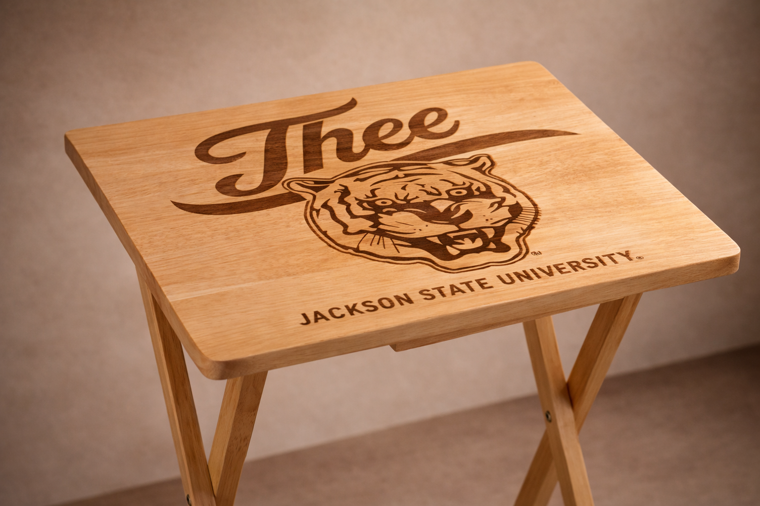 Light wood folding tray table with engraved “J’thee” script, tiger crest, and Jackson State University