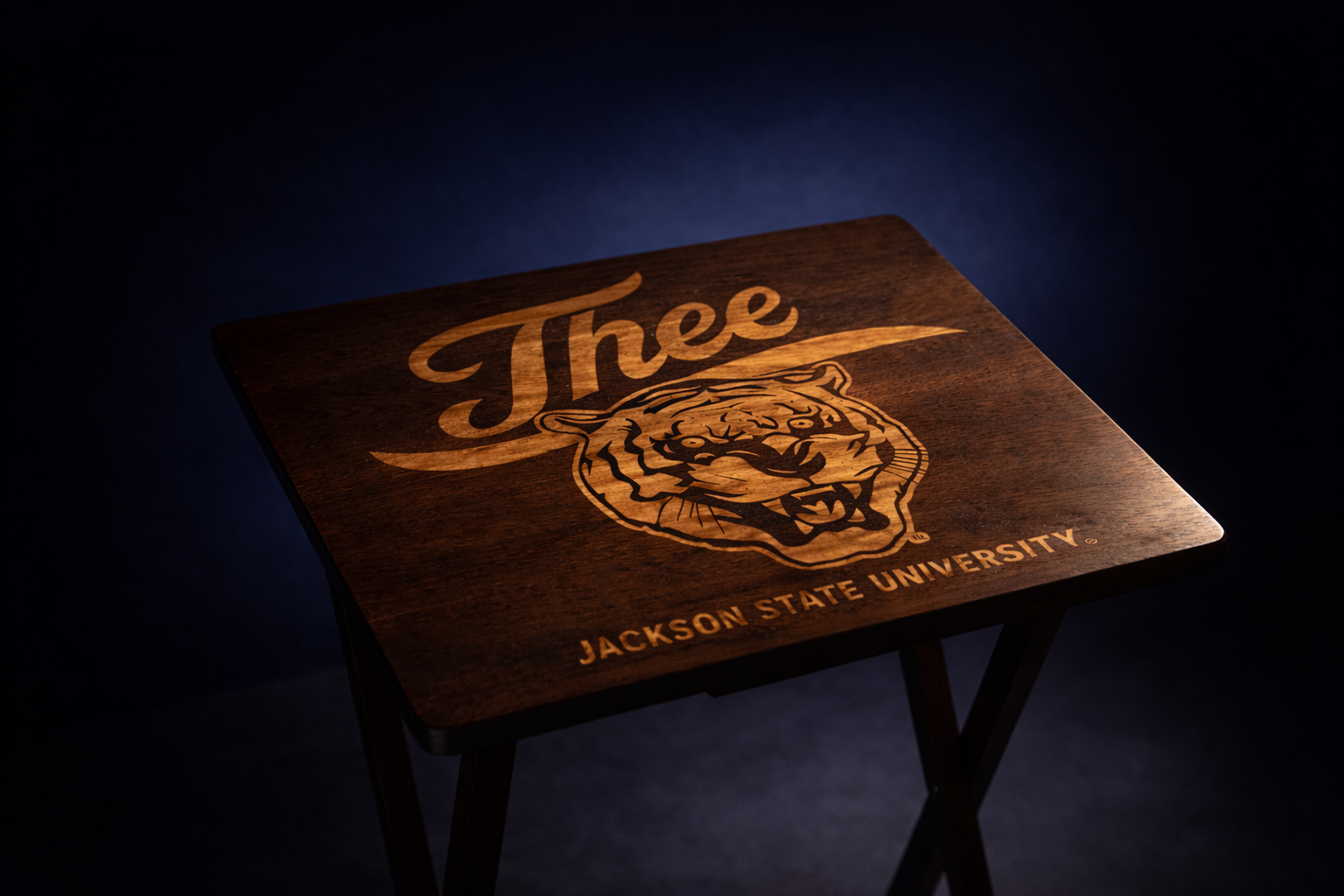 Dark walnut folding tray table with engraved “J’thee” and Jackson State University tiger crest