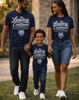 Family of three wearing matching navy blue t-shirts with 'The Legacy Continues' text, walking outdoors.