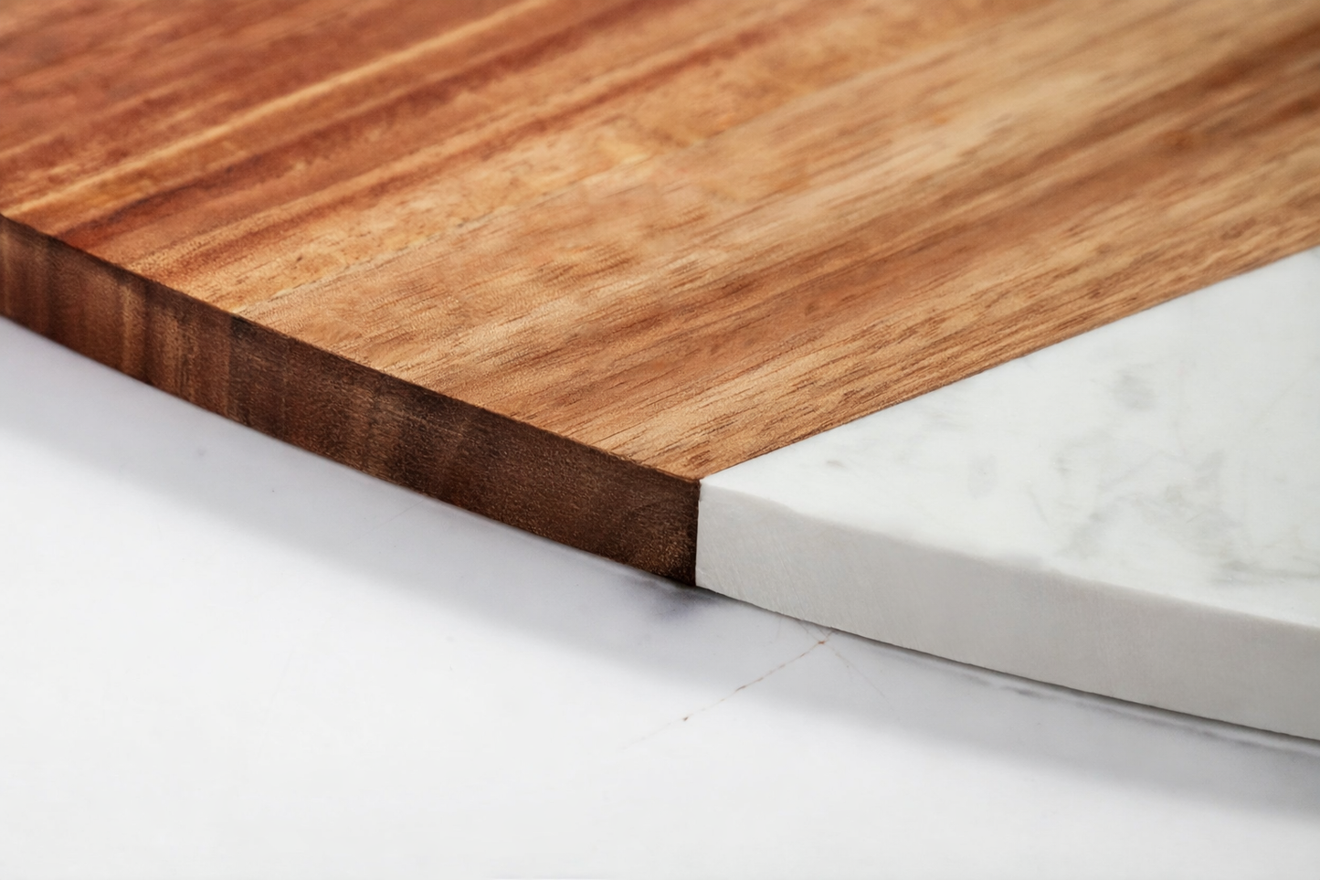 Close-up of a wooden and marble cutting board on a white surface