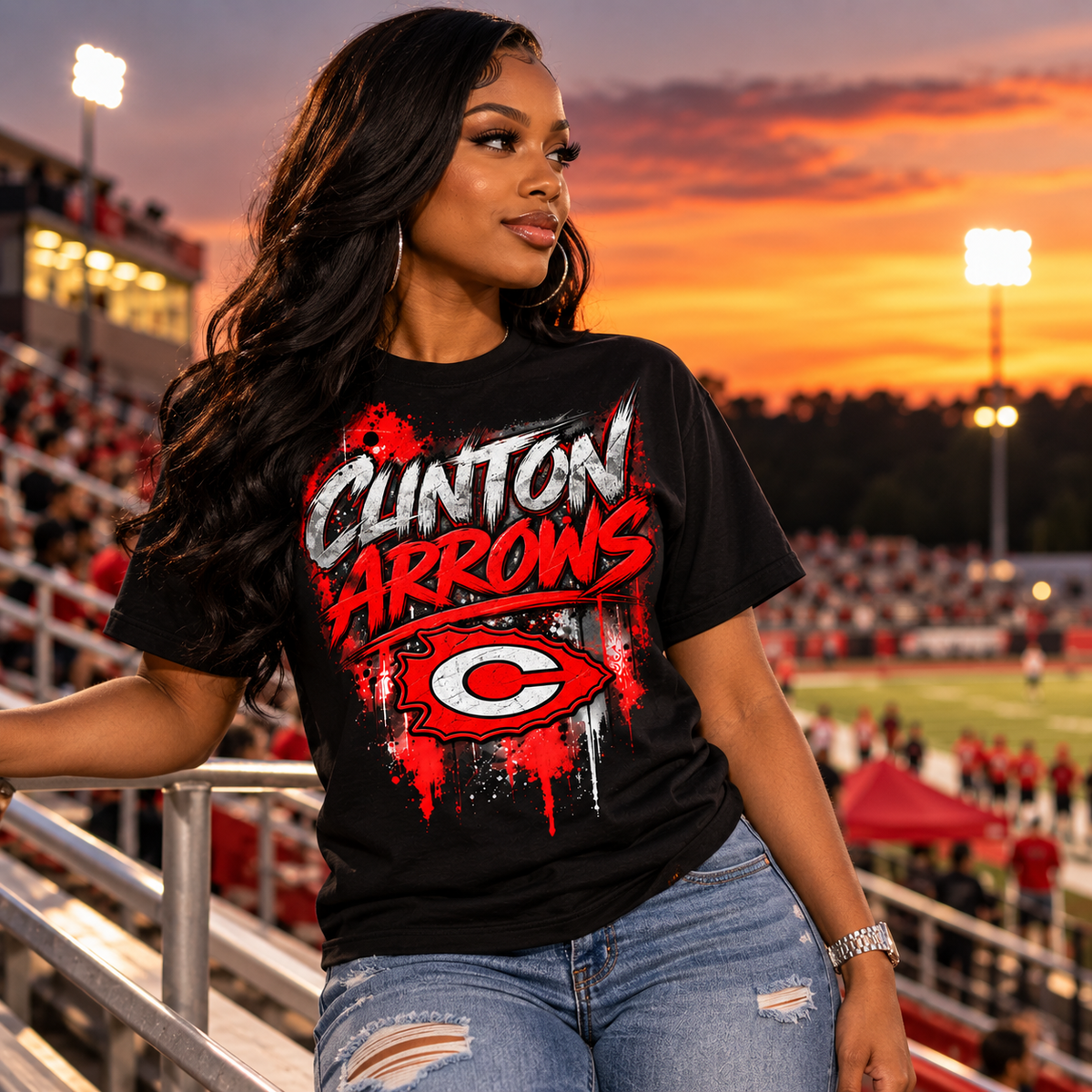 Young woman wearing black Clinton Arrows graffiti T-shirt at a football stadium