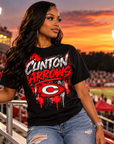Young woman wearing black Clinton Arrows graffiti T-shirt at a football stadium