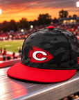 Clinton Arrows New Era camo snapback on football stadium bleachers
