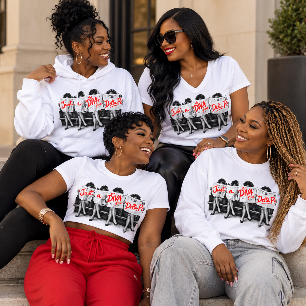 Four Black women wearing Just A Diva from Delta Pi white apparel in an editorial lifestyle setting