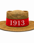 Straw hat with red band embroidered with “1913”