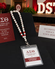Delta Sigma Theta conference badge attached to pearl beaded lanyard necklace at a sorority event setting