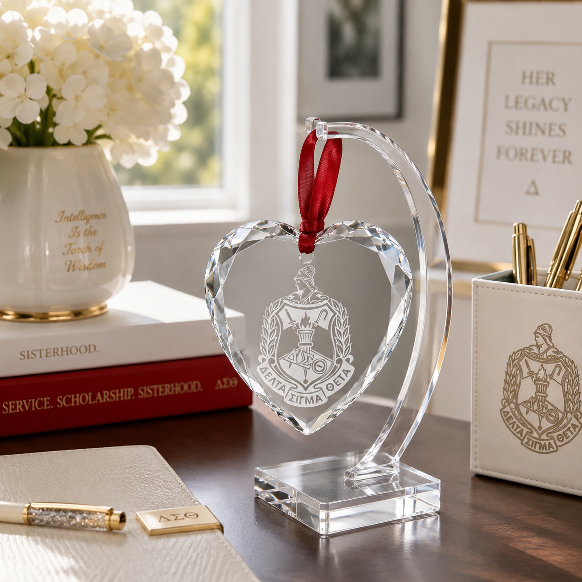 Engraved Delta Sigma Theta crystal heart displayed on an elegant crystal stand.