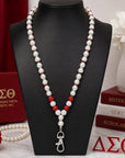 Delta Sigma Theta pearl beaded lanyard necklace with rhinestone spacers displayed on a black jewelry mannequin