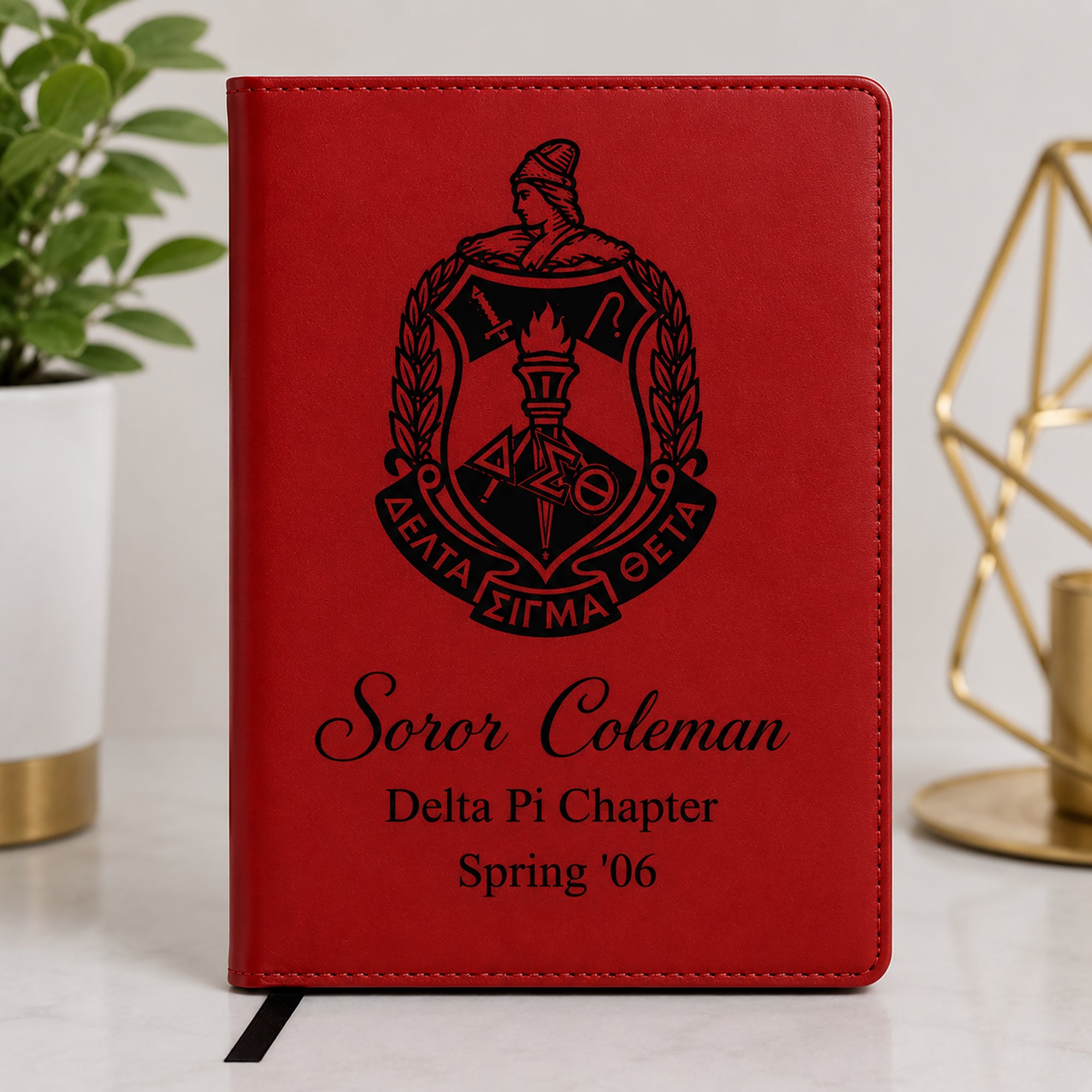 Red Delta Sigma Theta leatherette notebook featuring the official shield logo with personalized engraving for Soror Coleman, Delta Pi Chapter, Spring '06.