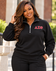Black woman showing the blank back and fit of a black ladies Delta Sigma Theta quarter-zip sweatshirt