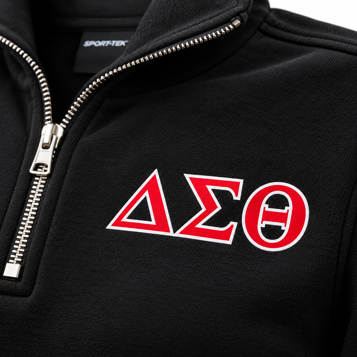 Close-up of red Delta Sigma Theta Greek letters with white outline printed on black fleece