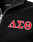 Close-up of red Delta Sigma Theta Greek letters with white outline printed on black fleece
