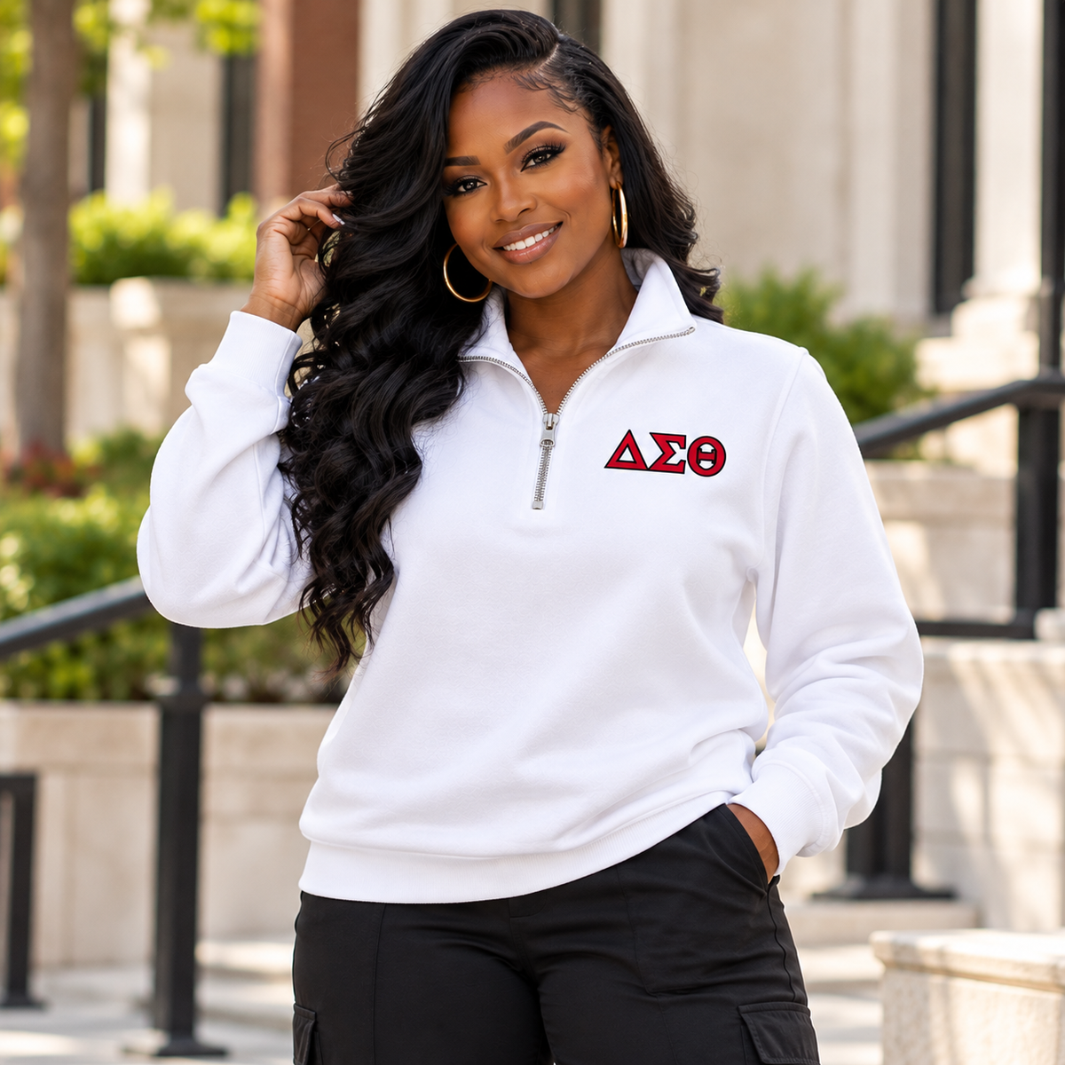 Black woman modeling a white unisex Delta Sigma Theta quarter-zip sweatshirt