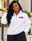 Black woman modeling a white unisex Delta Sigma Theta quarter-zip sweatshirt