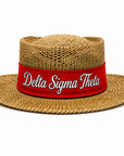 Straw hat with red band embroidered with Delta Sigma Theta script