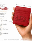 Delta Sigma Theta faux leather slim wallet shown in hand to demonstrate its compact everyday size.
