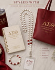 Delta Sigma Theta pearl lanyard styled with matching tumbler notebook tote bag and bracelet accessories