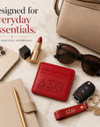 Delta Sigma Theta faux leather slim wallet styled with a handbag, planner, phone, keys, sunglasses, and other everyday essentials.
