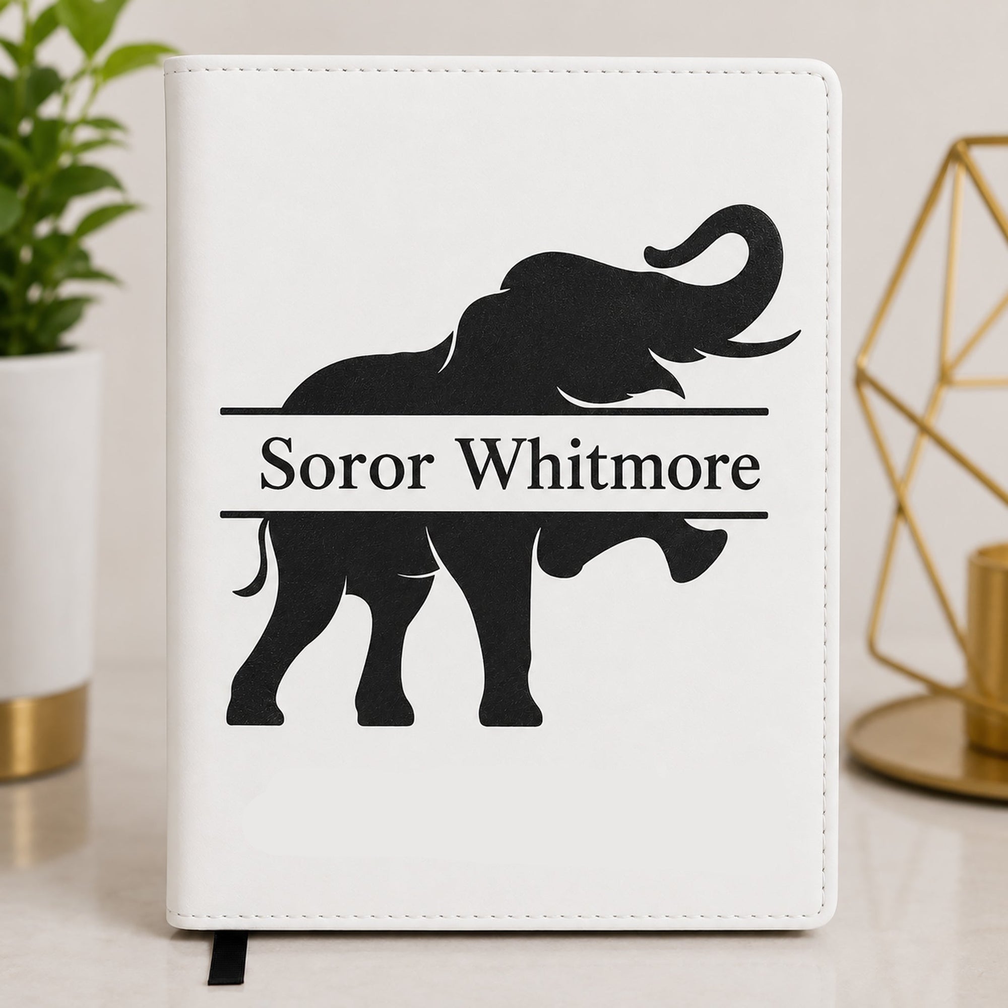 White Delta Sigma Theta leatherette notebook featuring an elephant silhouette with personalized Soror Whitmore engraving.