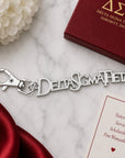 Delta Sigma Theta silver Greek letter keychain with lobster clasp on marble surface next to crimson gift box