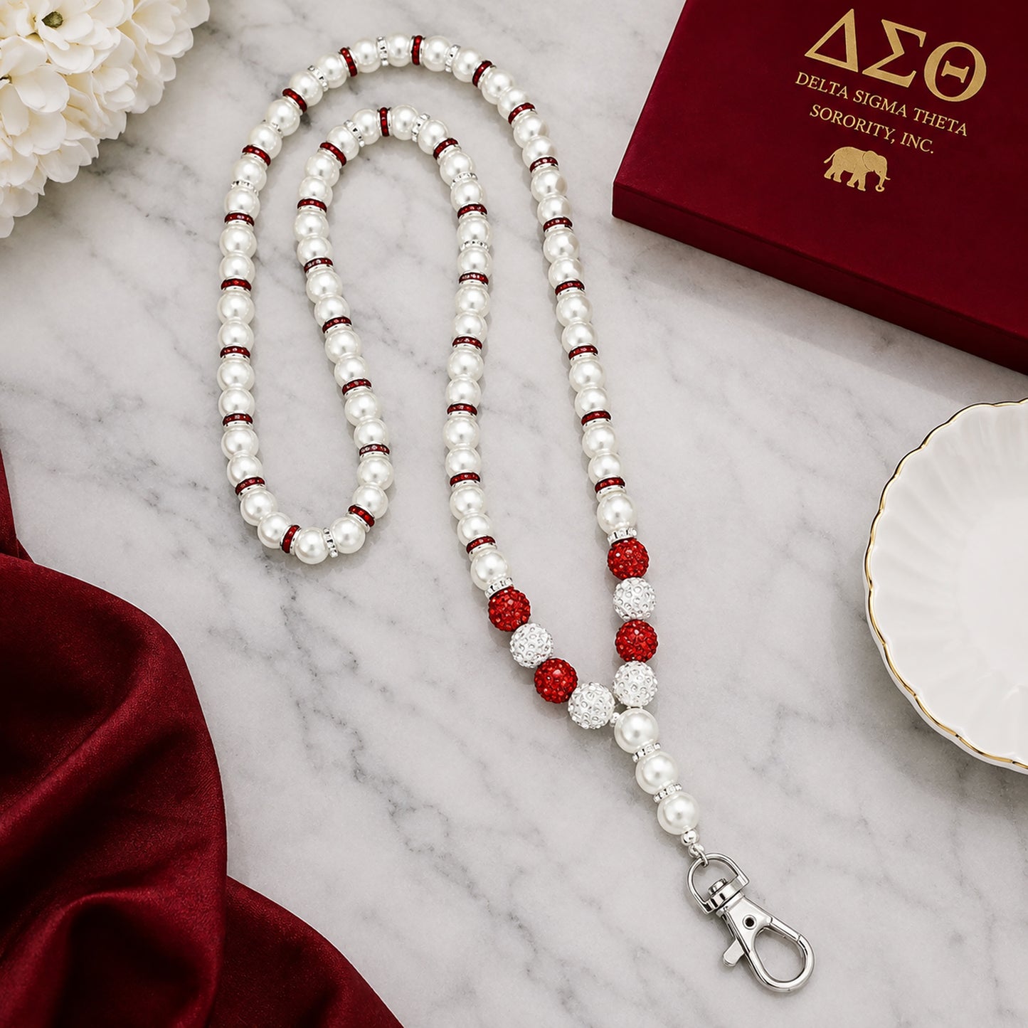 Close-up detail of pearl beads rhinestone spacers and crimson accent beads on Delta Sigma Theta lanyard necklace
