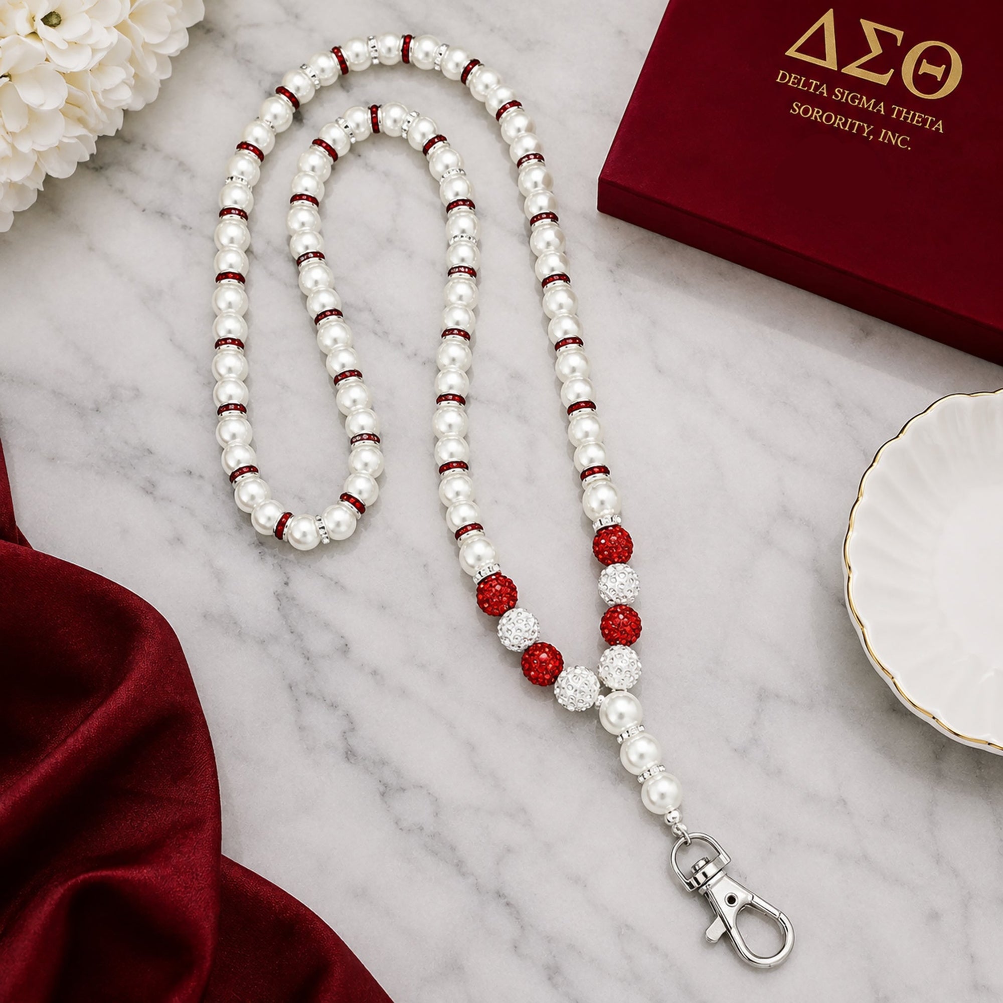Close-up detail of pearl beads rhinestone spacers and crimson accent beads on Delta Sigma Theta lanyard necklace